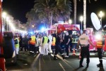 Police officers, firefighters and rescue workers are seen at the site of an attack on July 15, 2016, after a truck drove into a crowd watching a fireworks display in the French Riviera town of Nice. A truck ploughed into a crowd in the French resort of Nice on July 14, leaving at least 60 dead and scores injured in an "attack" after a Bastille Day fireworks display, prosecutors said on July 15. / AFP PHOTO / Valery HACHE